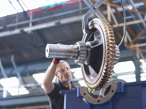 Engineer Assembling Industrial Gearbox In Engineering Factory