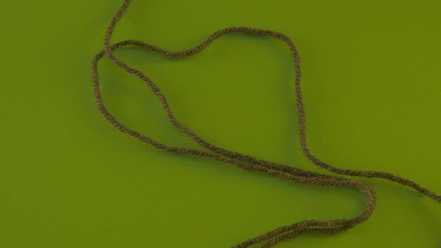 Someone is Pulling Green Yarn Away on Green Screen Colorful Filament Fiber Clue Threads Are Moving Red Thread is Removed Wool Thread is Moving Slowly