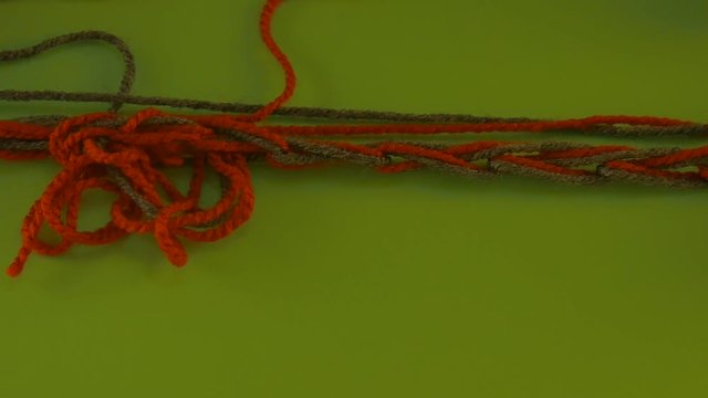 Tangled Yarn Wool on Green Screen Colorful Red and Green Threads Someone is Pulling Filament Fiber Threads Are Moving Someone is Pulling the Thread