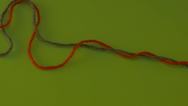 Someone is Pulling Green and Red Yarn on Green Screen Colorful Filament Fiber Clue Threads Are Moving Red Thread is Removed Wool Thread is Moving Slowly