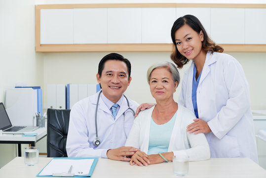 Vietnamese doctors and their senior patient in clinic