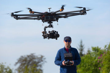 Drone, Unmanned copter flight, pilot  flying drone  - obrazy, fototapety, plakaty