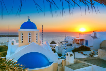 Picturesque view, Old Town of Oia or Ia on the island Santorini, white houses and church with blue...