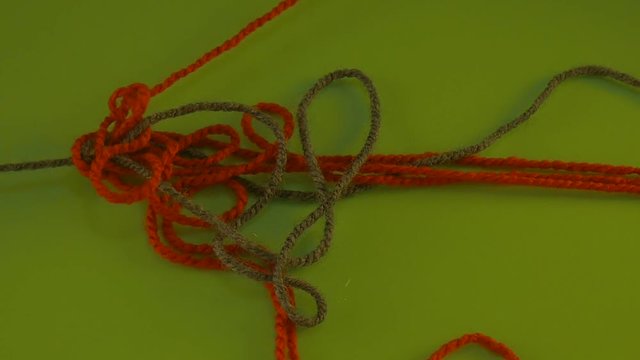 Wool Red Green Tangled Threads of Wool on Green Screen Colorful Fiber Someone is Pulling Filament Threads Are Moving Someone is Pulling the Thread