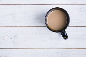 Coffee cup on the white wooden background