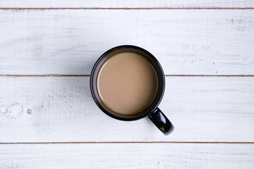 Coffee cup on the white wooden background