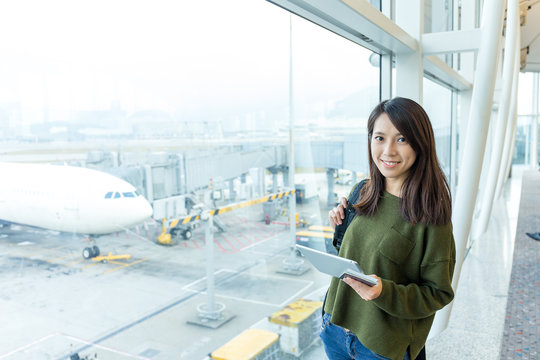 Woman Holding Tablet Pc In Airport