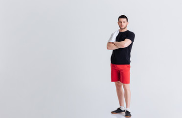 Fitness man standing with arms folded
