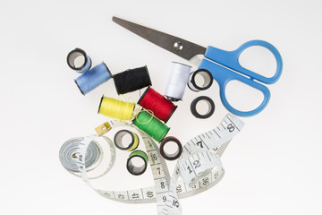 Accessories for needlework on wooden background.