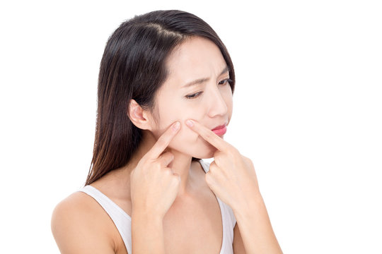 Young woman Squeezing pimple