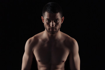 Naklejka premium Muscular man looking at camera