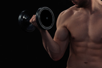 Obraz na płótnie Canvas Muscular man workout with dumbbell