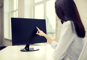 close up of woman with computer monitor in office