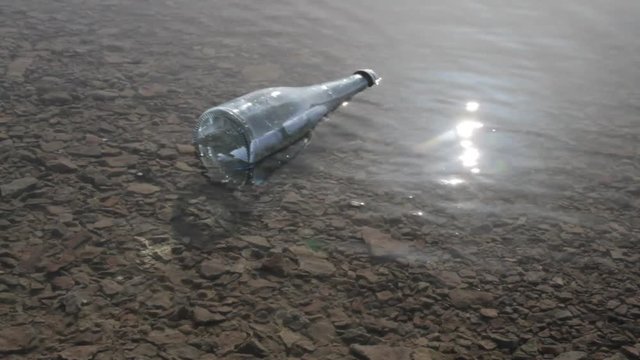 a bottle with a message in the water among the solar 
