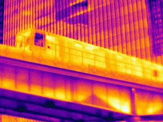 Low angle thermal photograph of train on bridge at Canary Wharf, London, UK