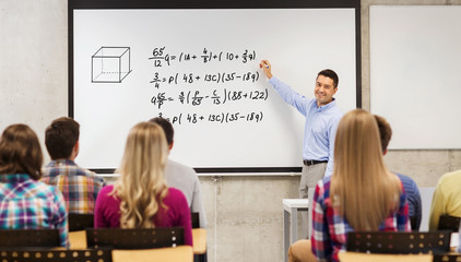 group of students and happy teacher at white board
