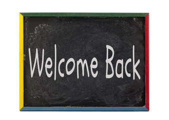 Fototapeta premium welcome back written on students slate board.