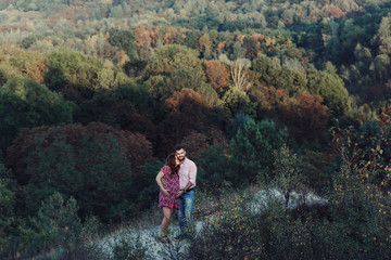 Fototapeta na wymiar Beautiful couple, husband & wife posing & hugging in forest, lan
