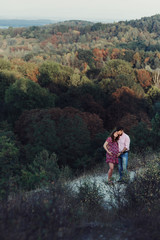 Beautiful couple, husband & wife posing & hugging in forest, lan