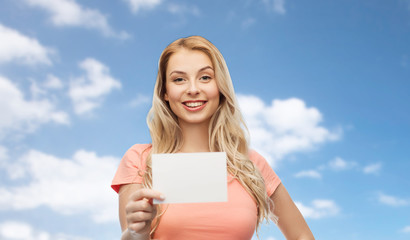 happy woman or teen girl with blank white paper