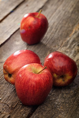 Red apples, on wooden surface.