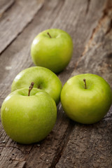 Green apples, on wooden surface.