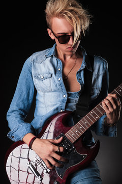 young blonde man playing rock and roll music