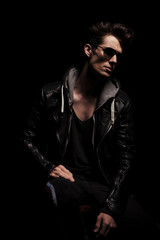 Fototapeta na wymiar side view of dramatic young man in leather jacket