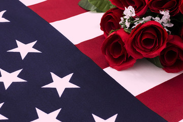 Fototapeta premium Bouquet of roses on American flag - close up