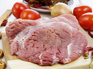 fresh pork steak on wooden Board