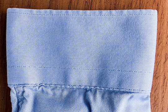 Detail Of Sleeve Shirt Texture Over Wooden Background