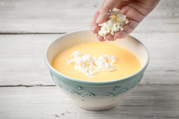 Adding fresh cheese in the eggs topping