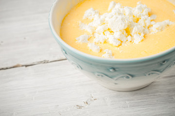 Topping of eggs , fresh cheese and yogurt in the ceramic bowl