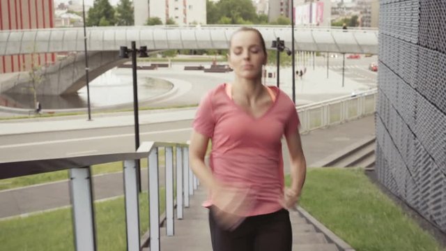 Athletic woman running on stairs - interval training