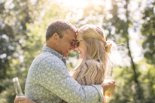 Romantic Mature Man Hugging Girlfriend In Garden