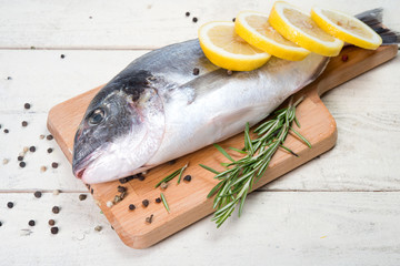 Fresh crude fish with a lemon for preparation 
