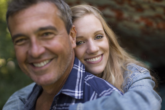 Portrait of mature man and young blond haired girlfriend