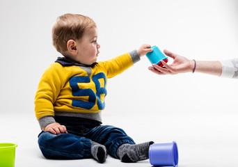 adult hand passes the baton to the baby hand