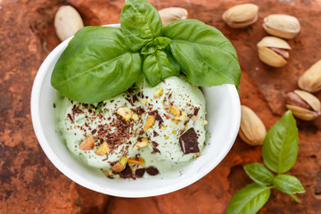 Homemade organic green ice cream - Basil, pistachio, green tea, mint. A refreshing summer dessert. Selective focus
