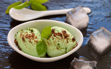 Homemade organic ice cream green tea with chocolate and mint . A refreshing summer dessert. Selective focus
