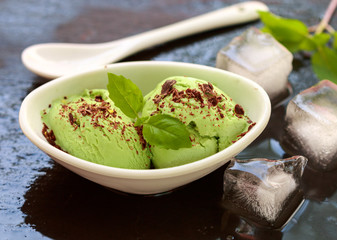 Homemade organic ice cream green tea with chocolate and mint . A refreshing summer dessert. Selective focus
