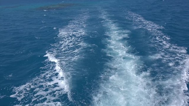 Speedboat wake prop wash at blue ocean in a sunny day. Bermuda