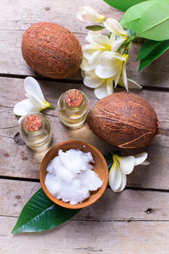 Coconuts and coconut oil on  vintage wooden background.