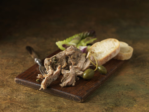 Christmas snack of pork rillette with ciabatta, green salad leaves and caper berries