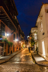 People walk at the streets of Cartagena during the evening.