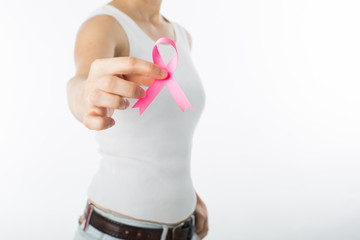 .Pink Breast cancer awareness ribbon holding by woman