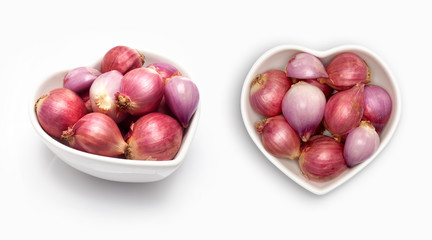 Shallot in a heart shaped bowl, isolated on white