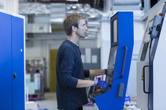 Factory technician working on control panel