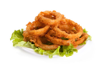 Fried onion rings on lettuce leaf