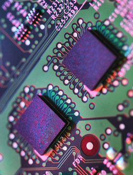Close up detail of green and purple computer circuit board
